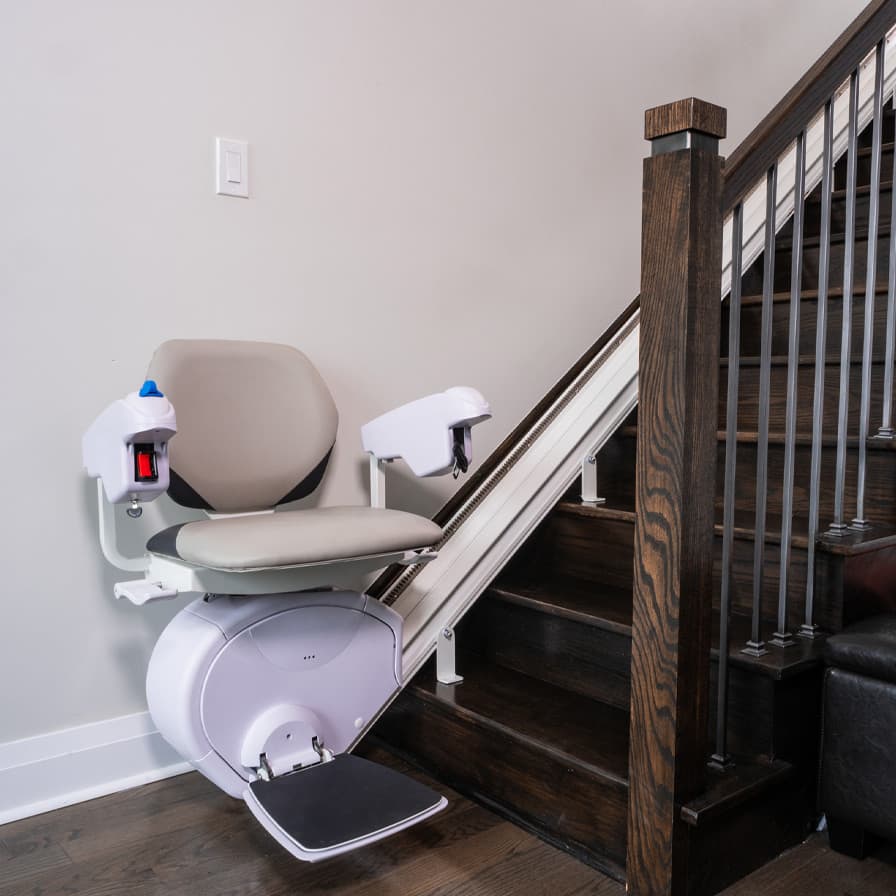 K2 Plus heavy duty stairlift with a plus seat at the bottom of residential straight staircase